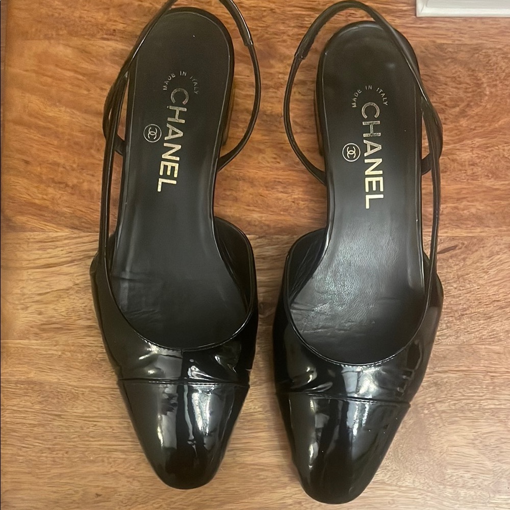 CHANEL classic flat slingback in black patent leather .